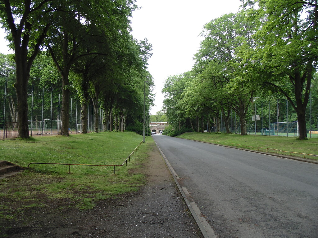 Zufahrt zum Fort Deckstein in Köln-Lindenthal. Links und rechts davon befinden sich Fußballplätze (2021).