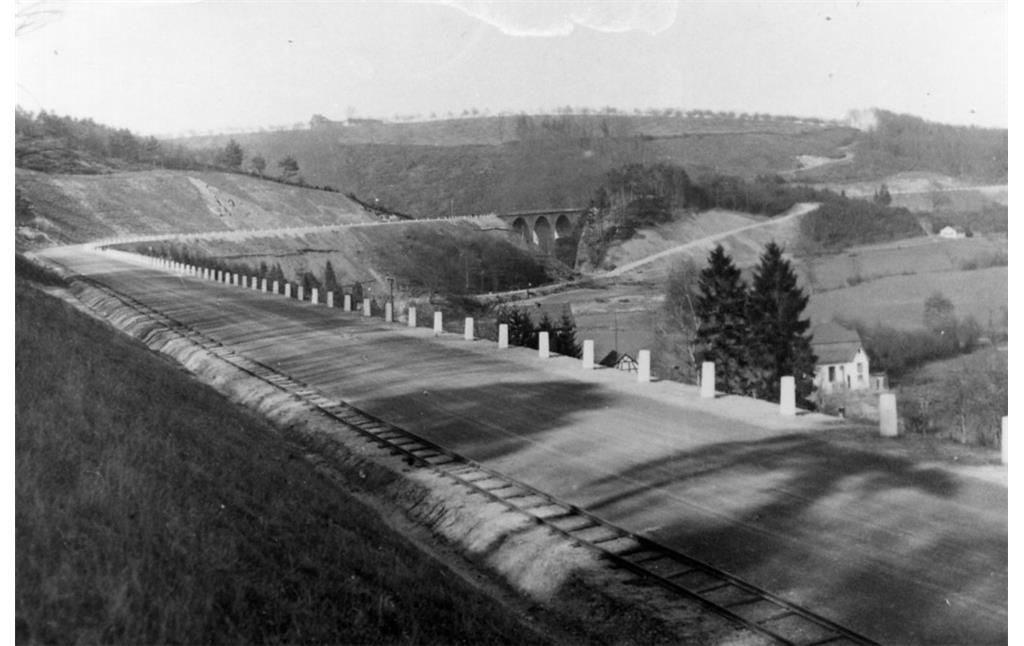 Die Wahnbachtalstraße mit der Ummigsbachtalbrücke im Bildhintergrund, im Vordergrund das Bauzuggleis (Aufnahme vor der Eröffnung 1927).