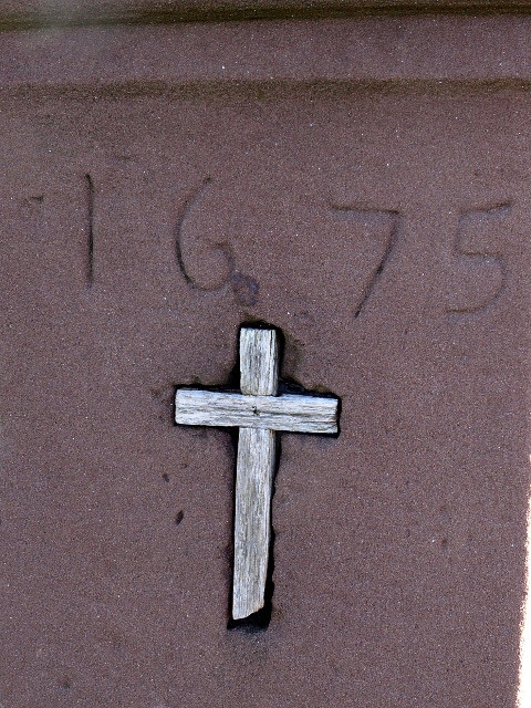 Detail am Eifelkreuz auf dem Kalvarienberg bei Alendorf, ein im Stein eingelassenes kleines Holzkreuz unter der Jahreszahl "1675" (2018).