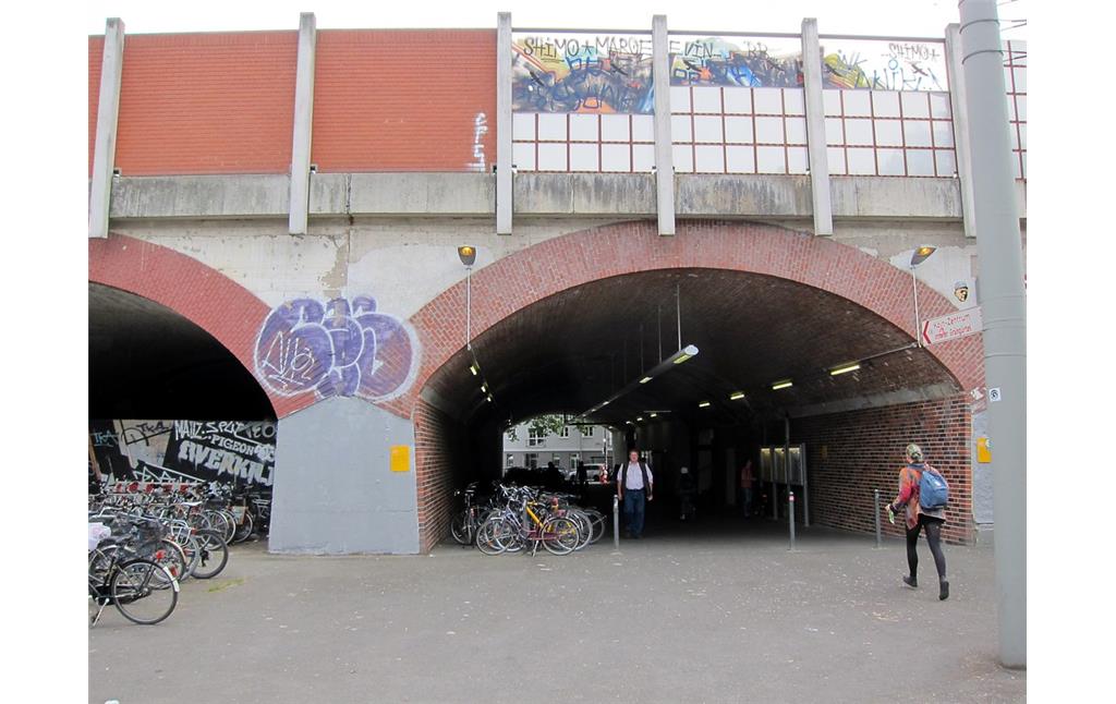Östlicher Zugang zum Bahnhof Köln-Ehrenfeld an der Ecke Ehrenfeldgürtel/Hüttenstraße (2015). Für den Zugang wurde eines der Gewölbe der Viaduktbrücke, auf der die Bahnstrecke hier verläuft, saniert und geöffnet.