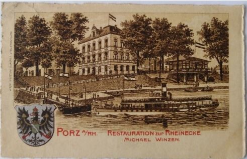 Eine historische Postkarte zeigt das Haus Bahnhofstraße Nr. 2 in Porz vom Rhein aus, nach Fertigstellung der Rampe und der Anlegebrücke. Hier befand sich einst das Restaurant "Zur Rheinecke". An der Stelle der kleinen Glashalle rechts im Bild befindet sich auch heute noch ein Restaurant.
