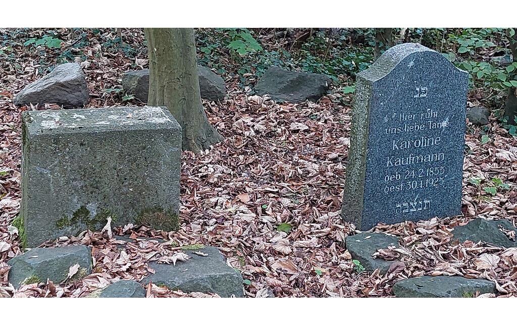 Grabsteine auf dem Jüdischen Friedhof am Rosenhügel in Köln-Zündorf (2022): links ein nur noch als Sockel erhaltener Grabstein, rechts die Grabstätte der Karoline Kaufmann (1855-1925).