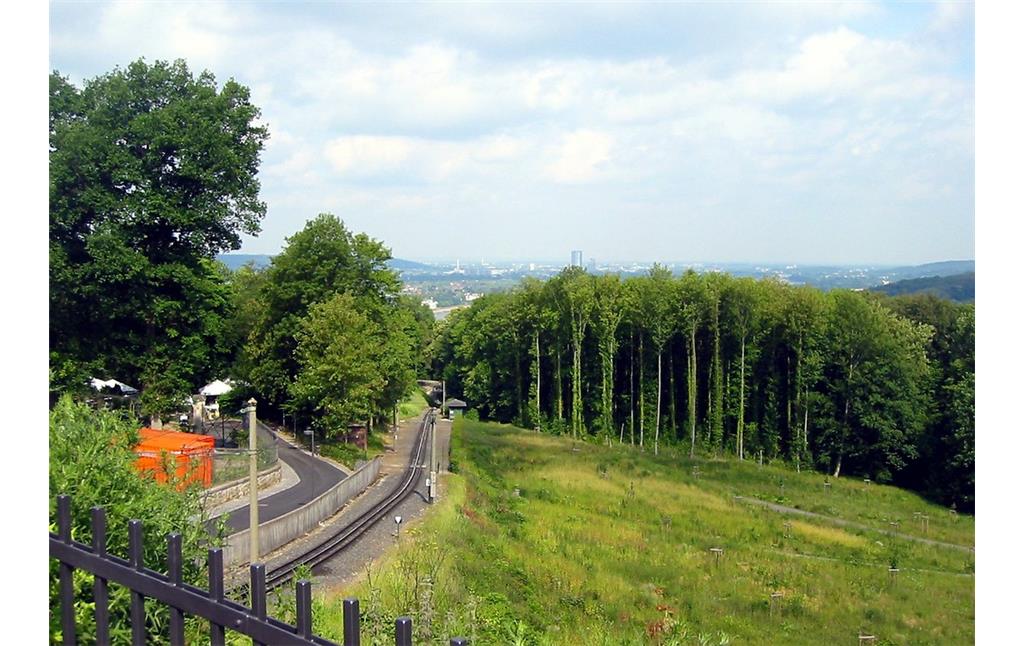 Blick vom Siebengebirge aus in Richtung Königswinter und Bonn über die Gleise und die Station "Schloss Drachenburg" der Drachenfels-Zahnradbahn hinweg (2011).