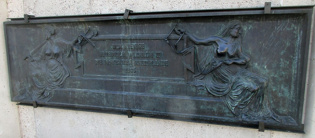 Bronzene Reliefplatte am Sockel des Reiterstandbilds auf dem Kölner Heumarkt mit der Inschrift "Dem Koenige Friedrich Wilhelm III die dankbaren Rheinlande 1865" (2018).