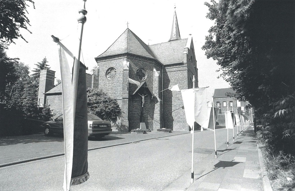 Fahnen vor der Pfarrkirche St. Hubertus in Etzweiler in den 1990er Jahren.