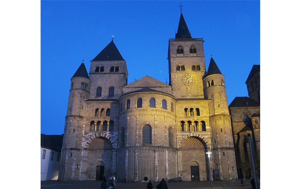 Abendliche Ansicht des Trierer Doms, vom Domfreihof aus gesehen (2014). Vor der Apsis des Westchors ist rechts der "Trierer Domstein" zu sehen.
