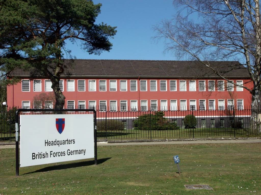 Ein Gebäude der militärischen Einrichtung "Joint Headquarters JHQ" in Rheindahlen, davor ein Hinweisschild auf das Hauptquartier der britischen Streitkräfte in Deutschland "Headquarter British Forces Germany" (2012).