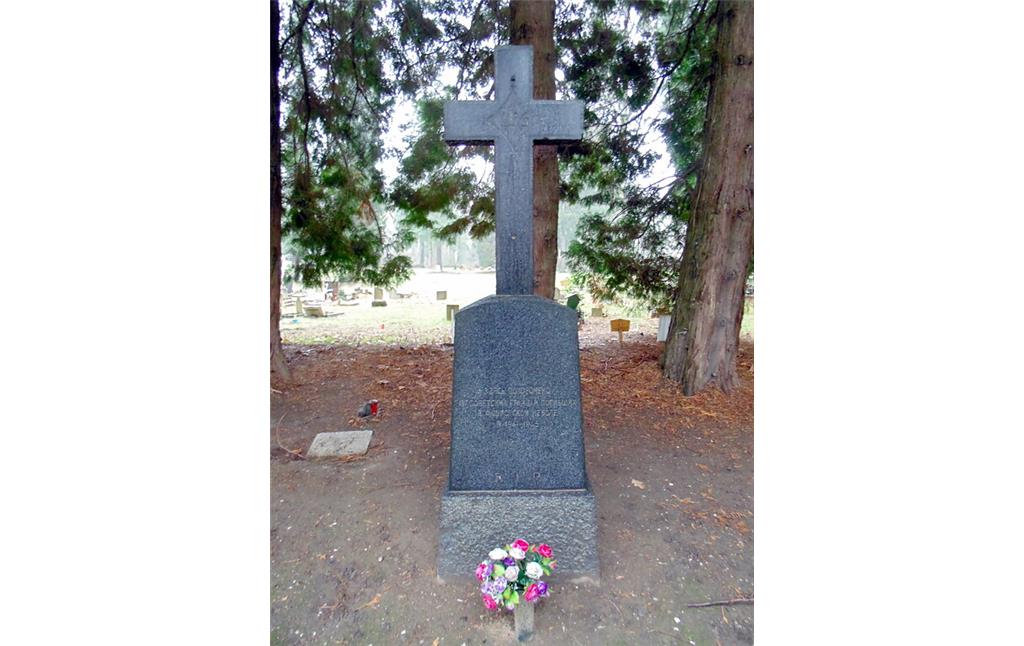 Das Grabkreuz auf dem Gräberfeld für sowjetische Kriegsgefangene auf dem Westfriedhof in Köln-Vogelsang (2021). Im Hintergrund links ist das einzige Frauengrab des Feldes zu sehen.