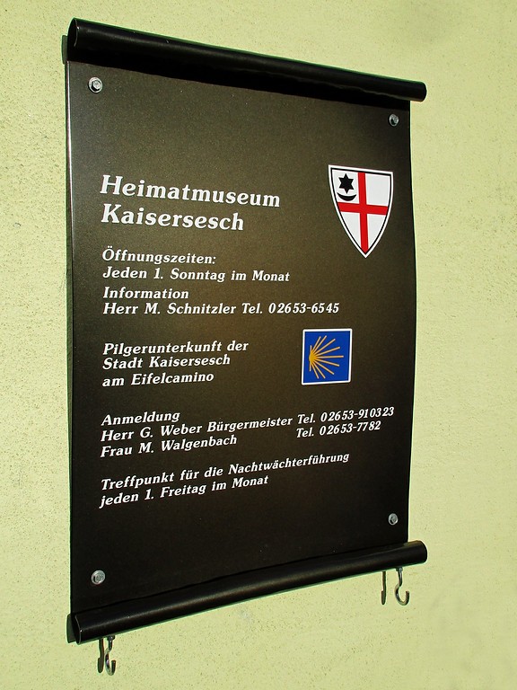 Hinweisschild zum Heimatmuseum und zur Pilgerunterkunft im früheren kurtrierischen Amtshaus und Burgmannenhaus Kaisersesch, dem alten Gefängnis "Büllesje" (2015).