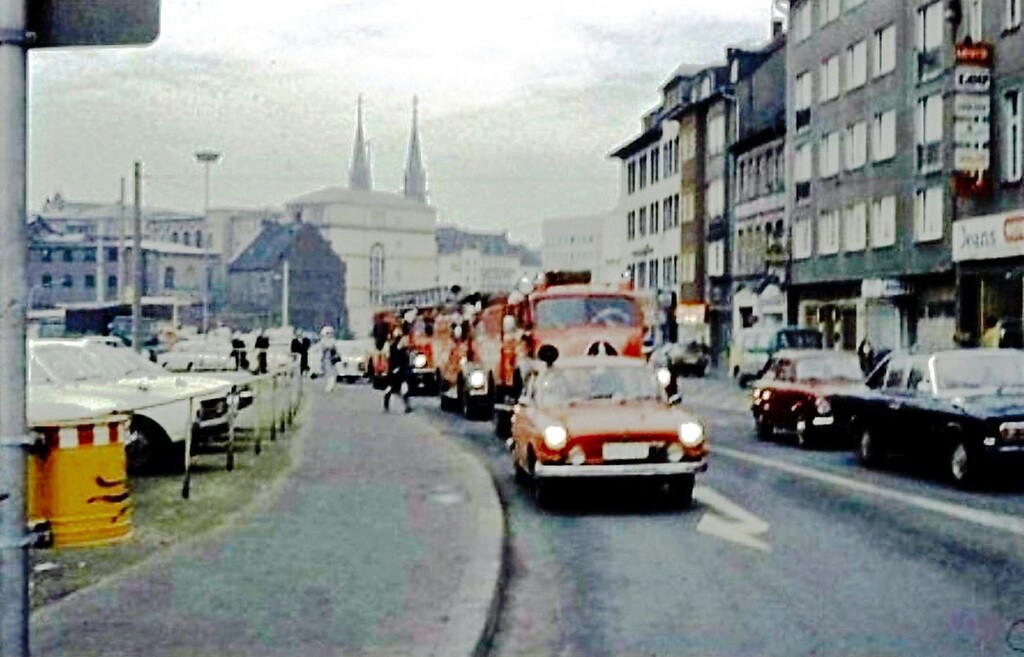 Ein von der Alten Feuerwache ausrückender Löschzug der Bonner Feuerwehr (1969), im Hintergrund sind die JVA Bonn und die Türme der Bonner Stiftskirche St. Johann Baptist und Petrus zu erkennen.