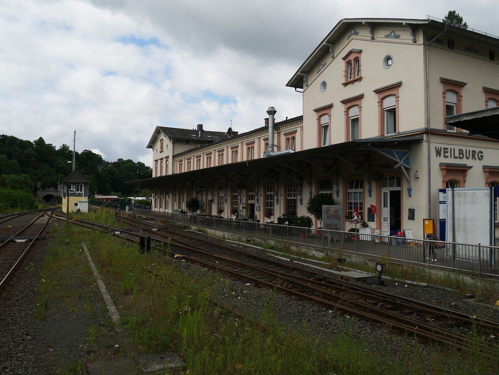 Hauptgebäude des Bahnhofs Weilburg mit Bahnsteig und Gleisanlagen im Vordergrund (2017)